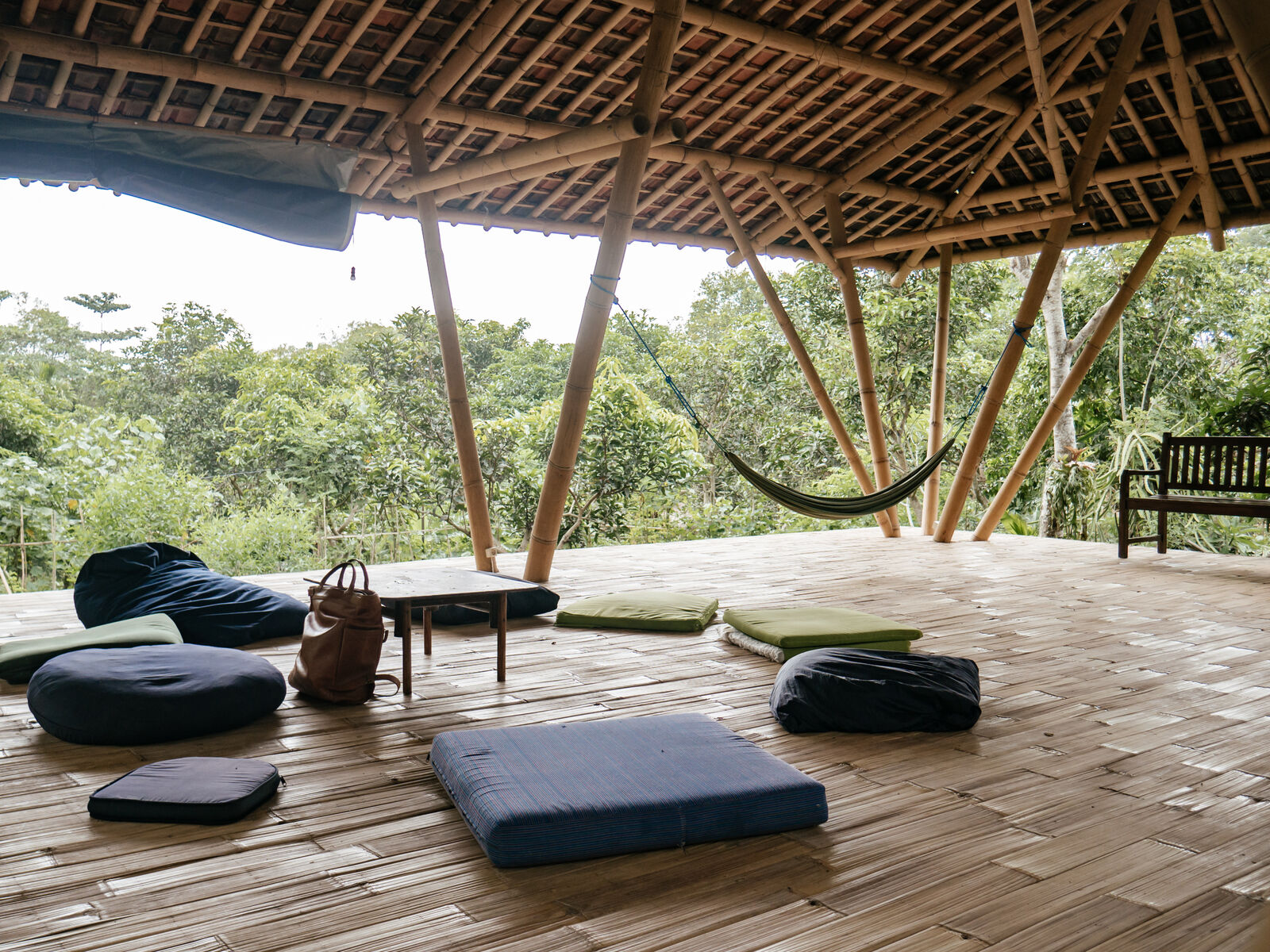 The open bamboo shala with cushions laid out on the floor.