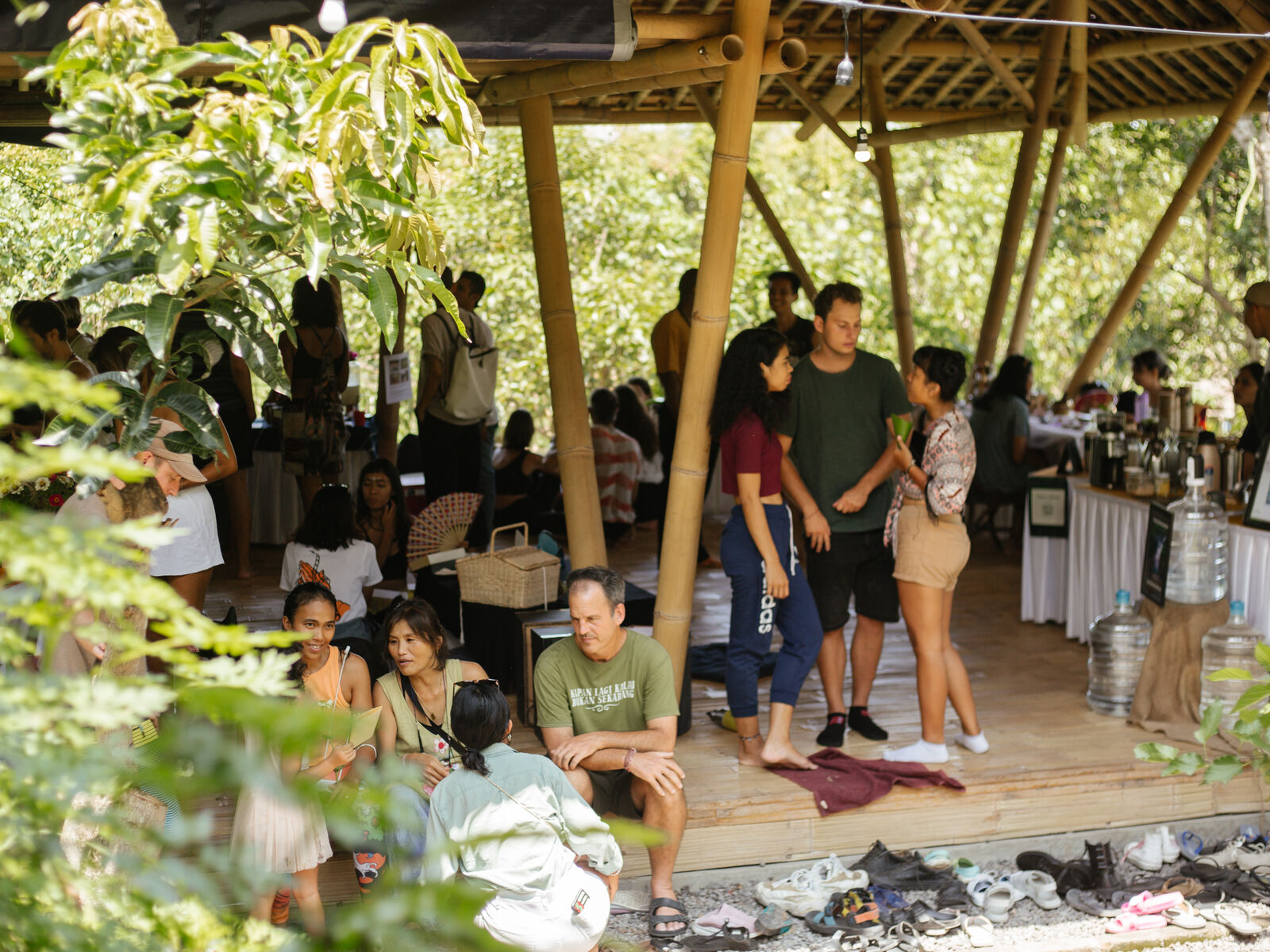 People gathered under the bamboo roof at a Pasar Jiwa market.